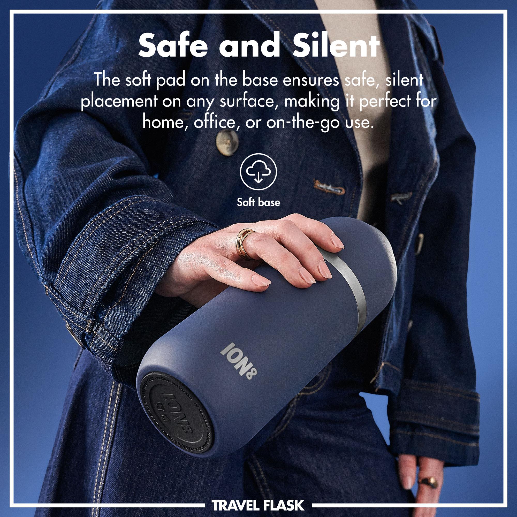 Person holding a blue travel flask with text about its safe and silent features.