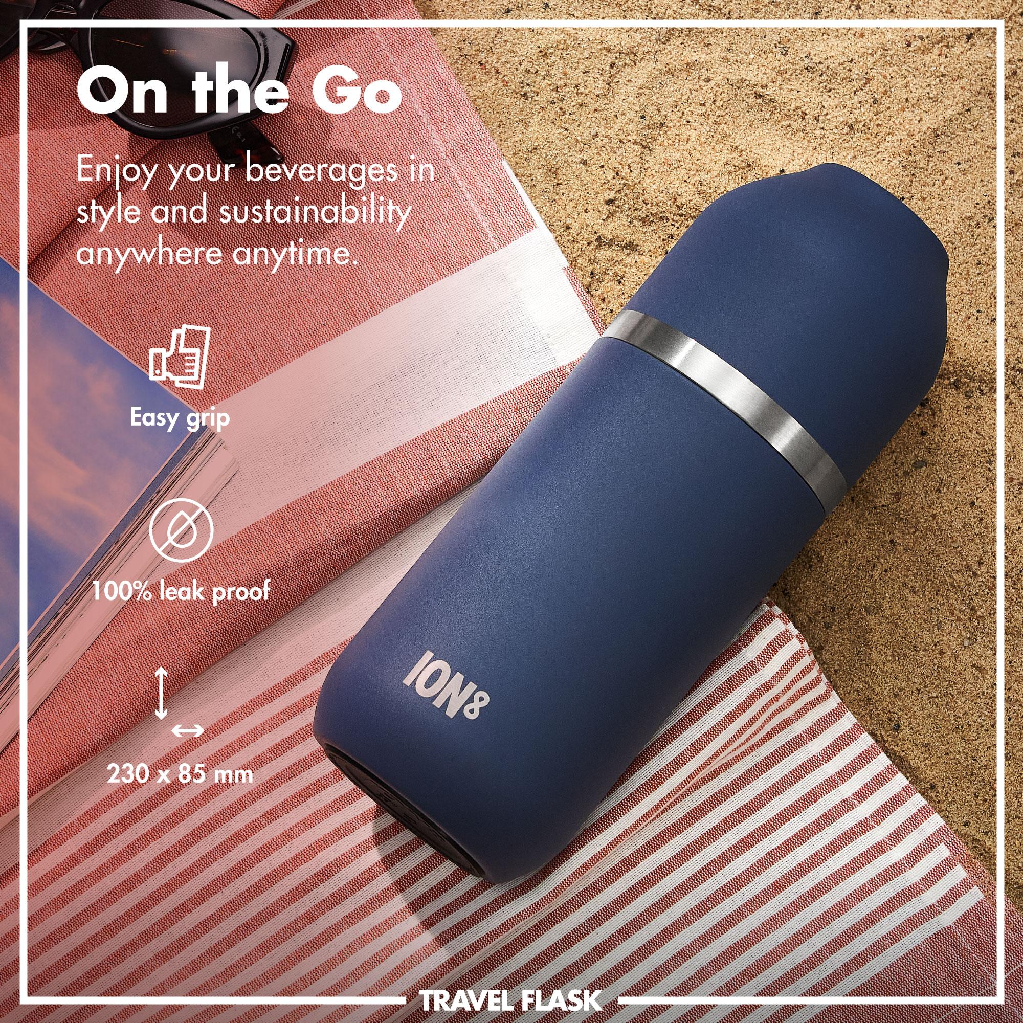 Blue ION8 travel flask with silver band on a striped fabric background, featuring text about its features.