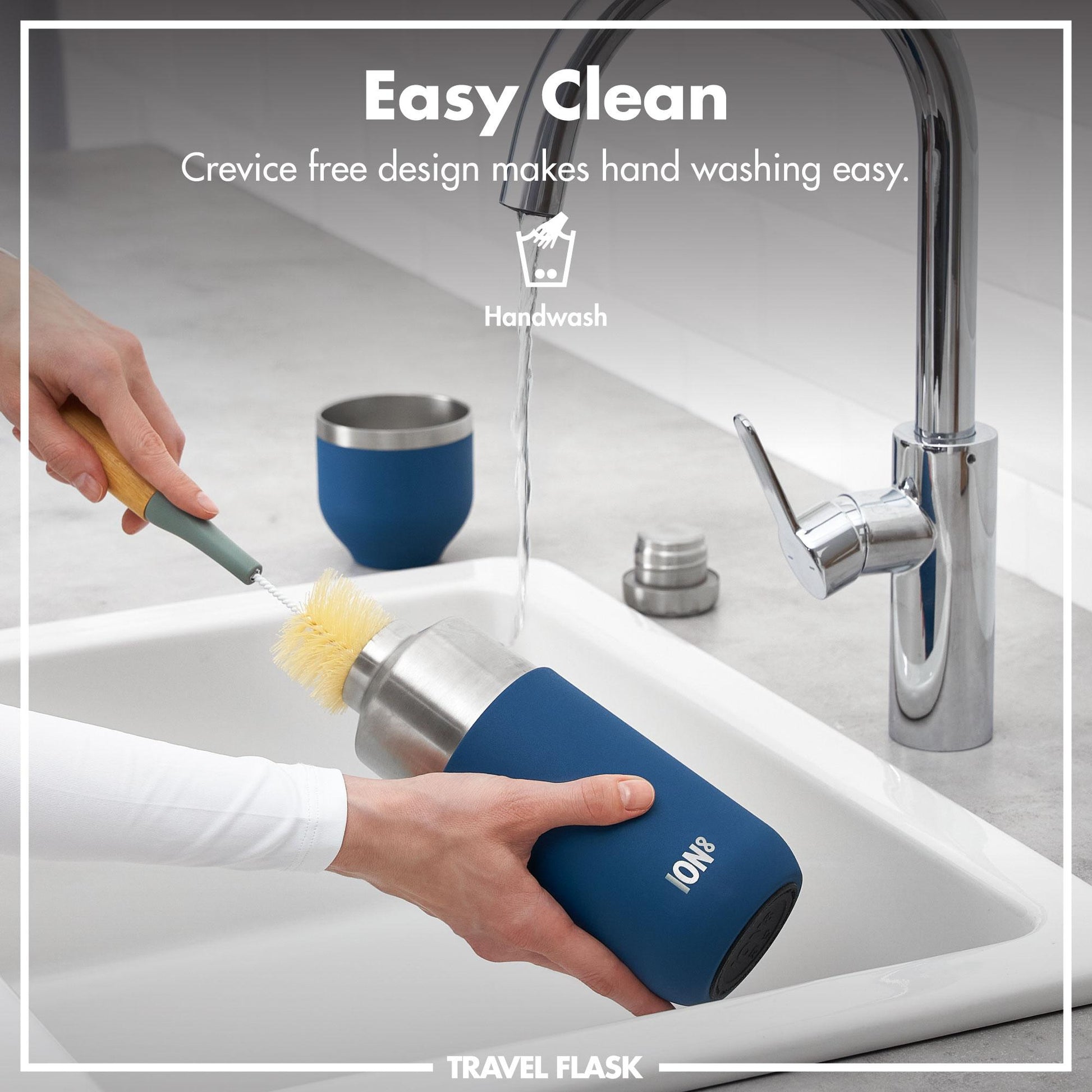Blue ION8 travel flask being cleaned with a brush in a sink, with text indicating easy cleaning design.